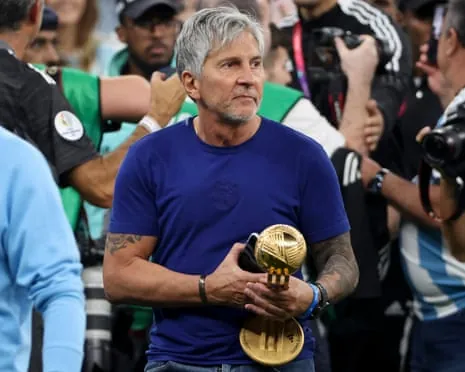 Jorge Messi, father and agent of Lionel Messi, holding his son's Golden Ball World Cup trophy